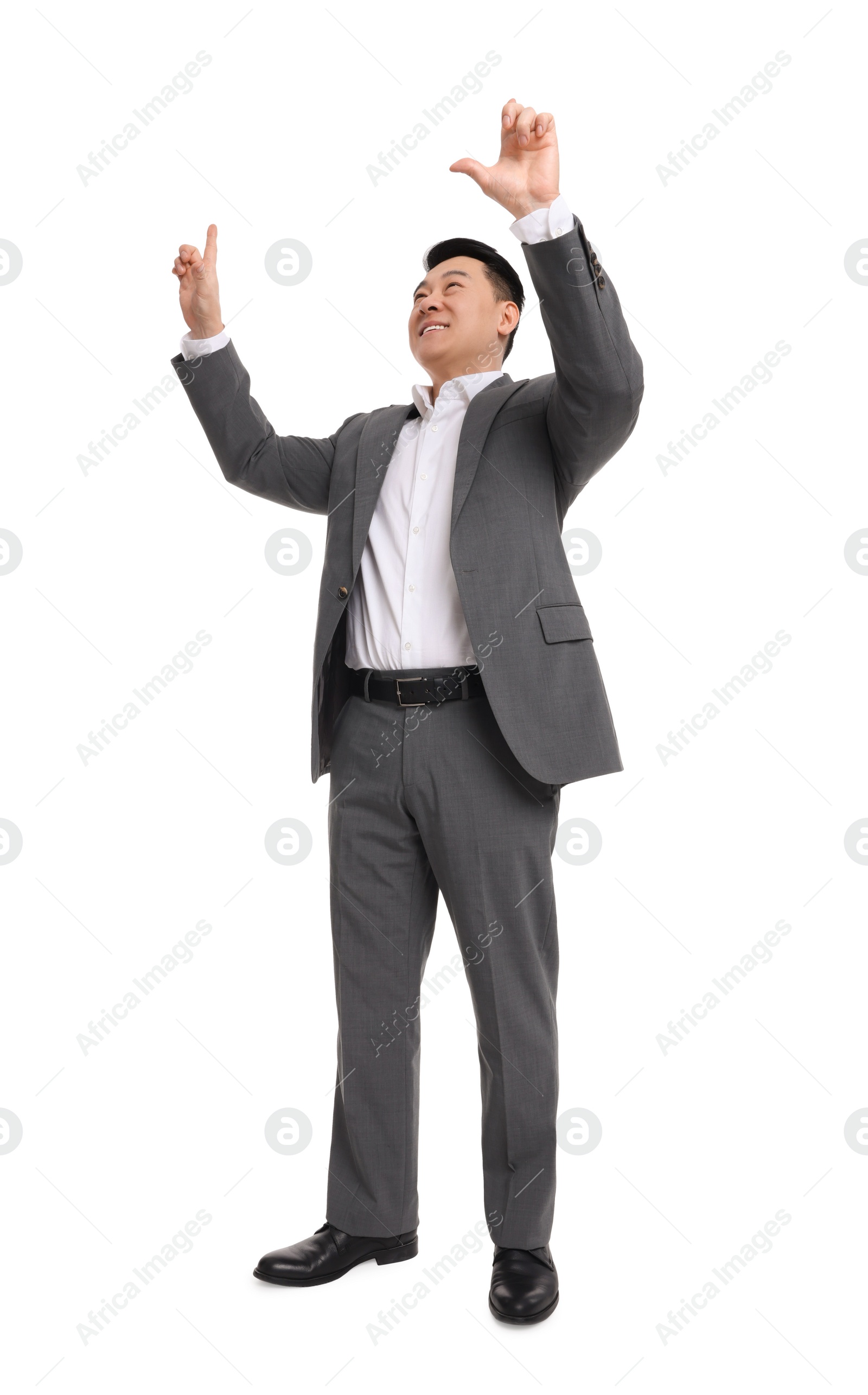 Photo of Businessman in suit posing on white background, low angle view