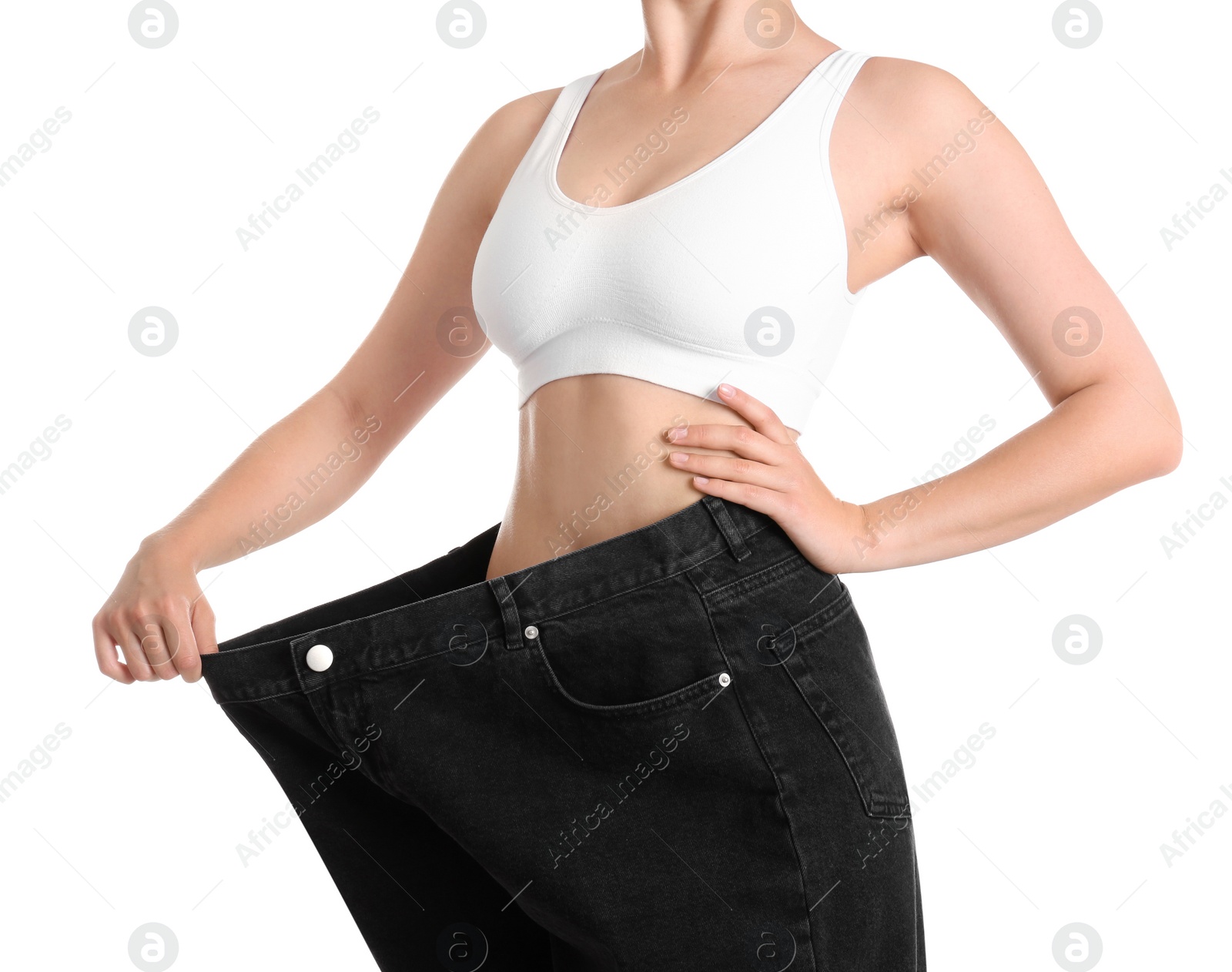 Photo of Young slim woman wearing oversized jeans on white background, closeup