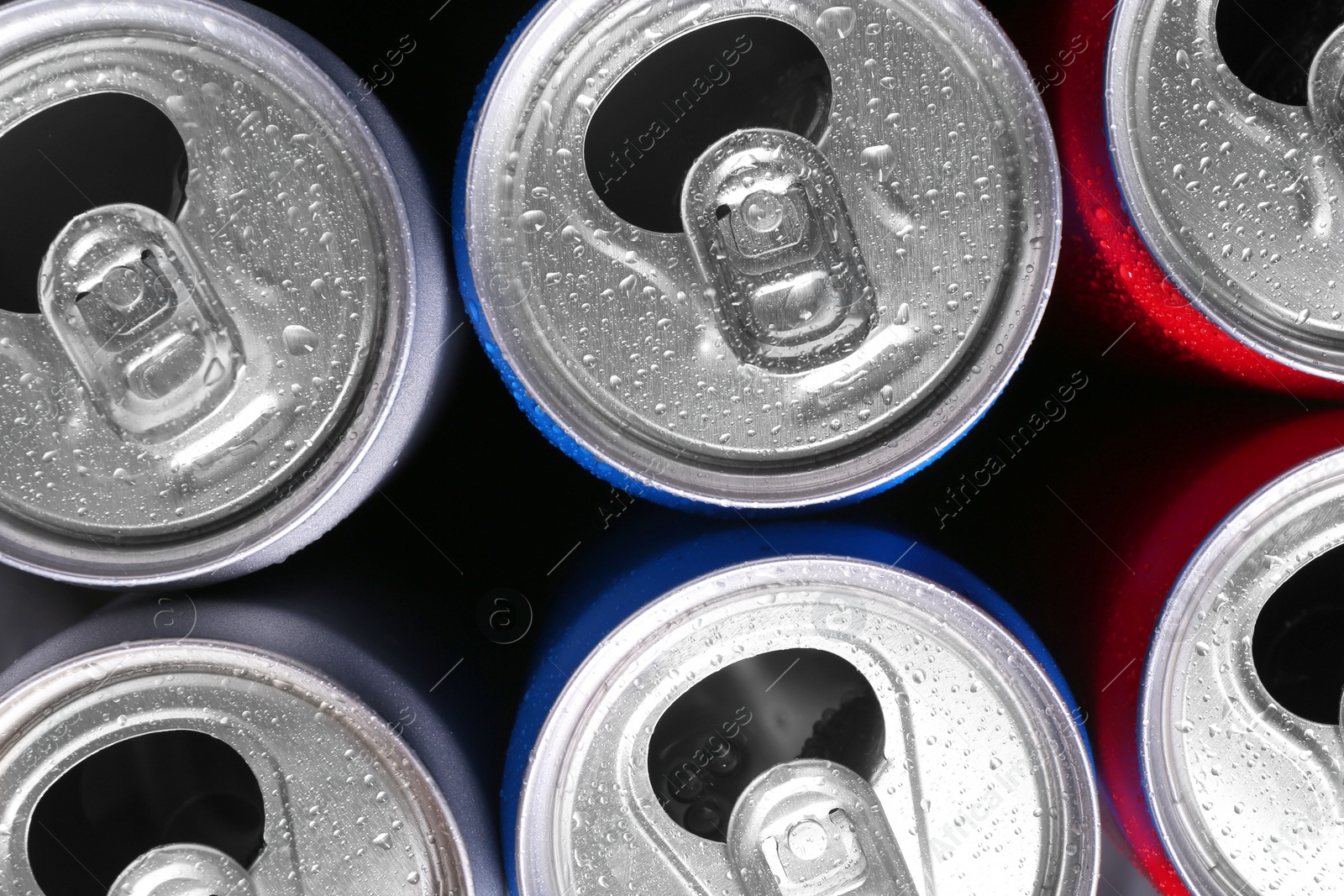 Photo of Energy drinks in wet cans as background, top view. Functional beverage