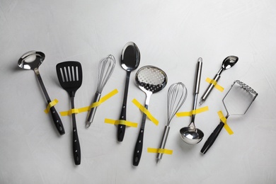 Set of clean kitchen utensils on grey background, flat lay