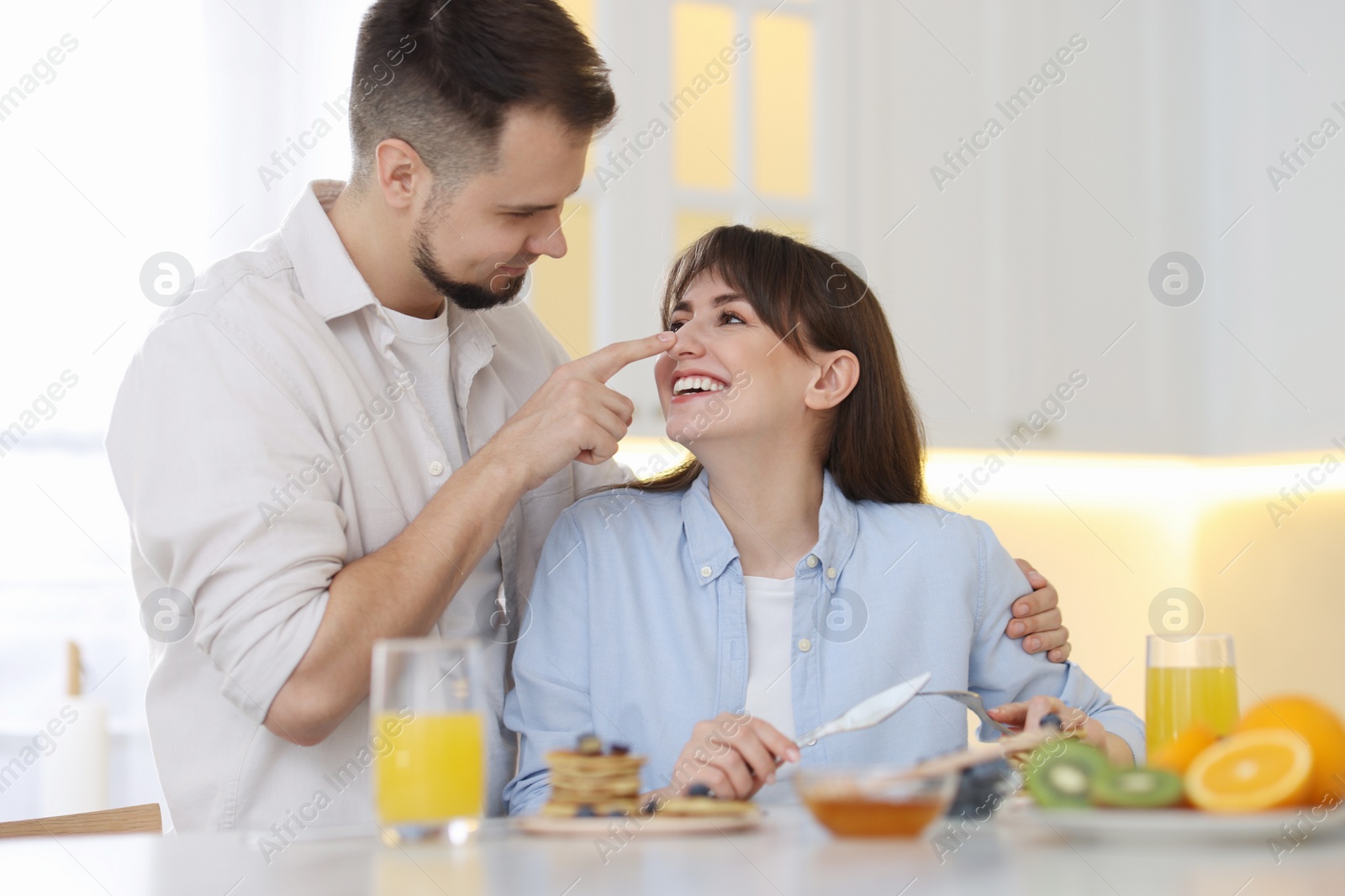 Photo of Happy couple spending time together during breakfast at home