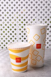 MYKOLAIV, UKRAINE - AUGUST 12, 2021: Cold McDonald's drinks on grey table