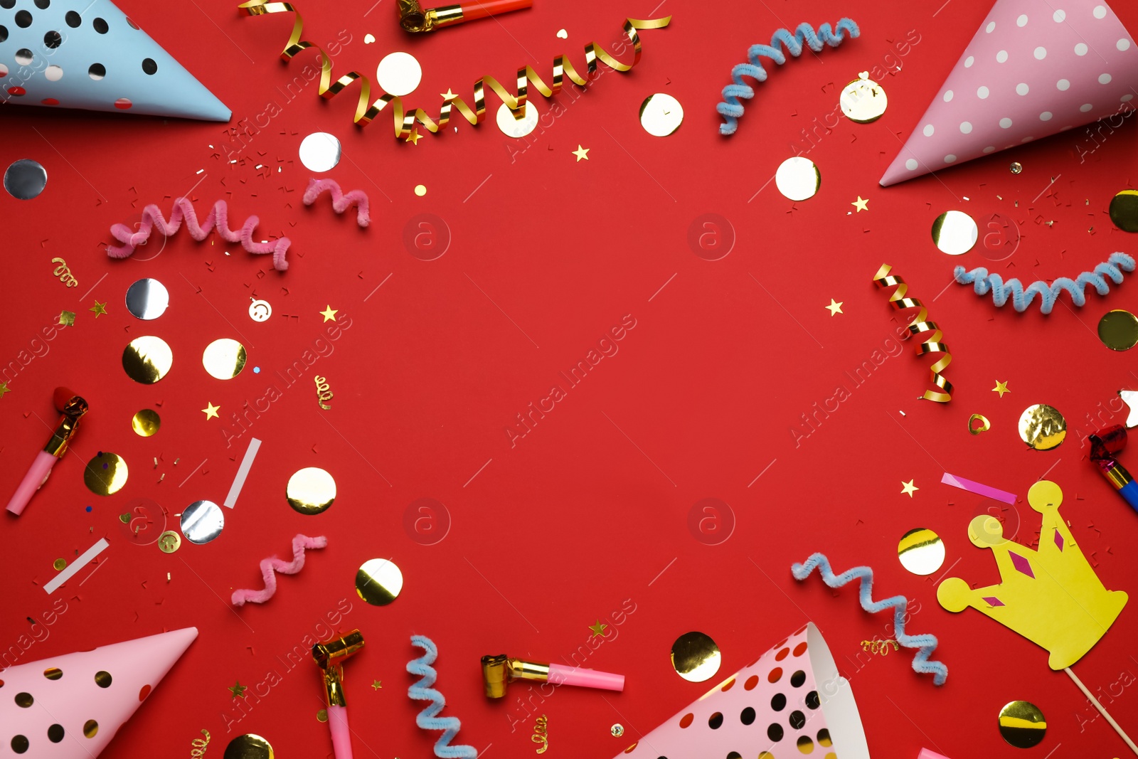 Photo of Frame of party items on red background, flat lay. Space for text