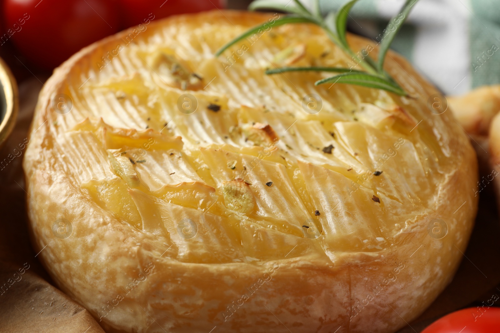 Photo of Tasty baked brie cheese with rosemary, closeup