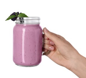 Photo of Woman with mason jar of delicious blackberry smoothie on white background, closeup