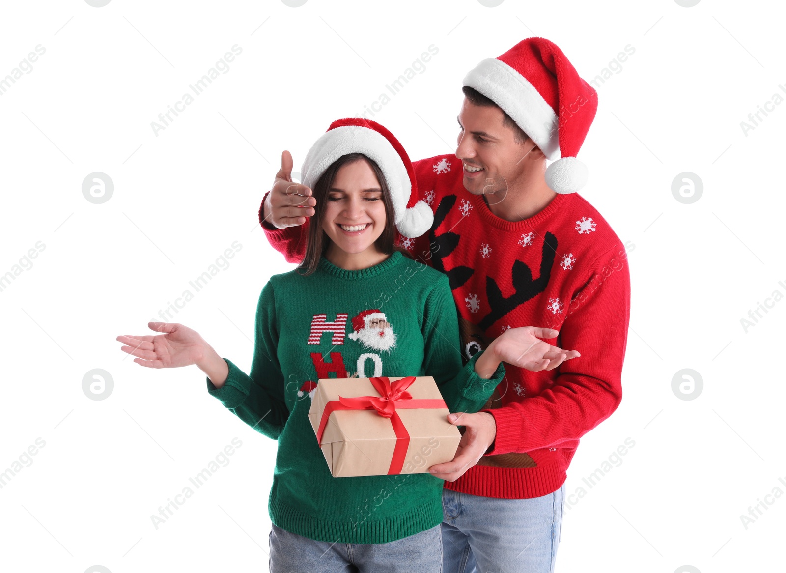 Photo of Man presenting Christmas gift to his girlfriend on white background