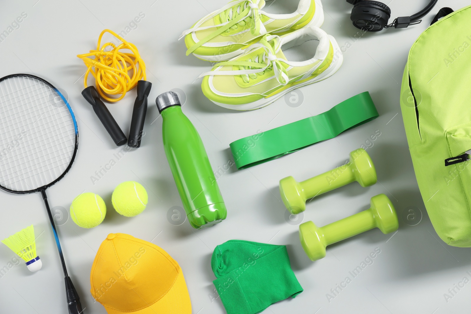 Photo of Different sports equipment on light grey background, flat lay