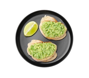 Delicious sandwiches with guacamole and lime wedge on white background, top view