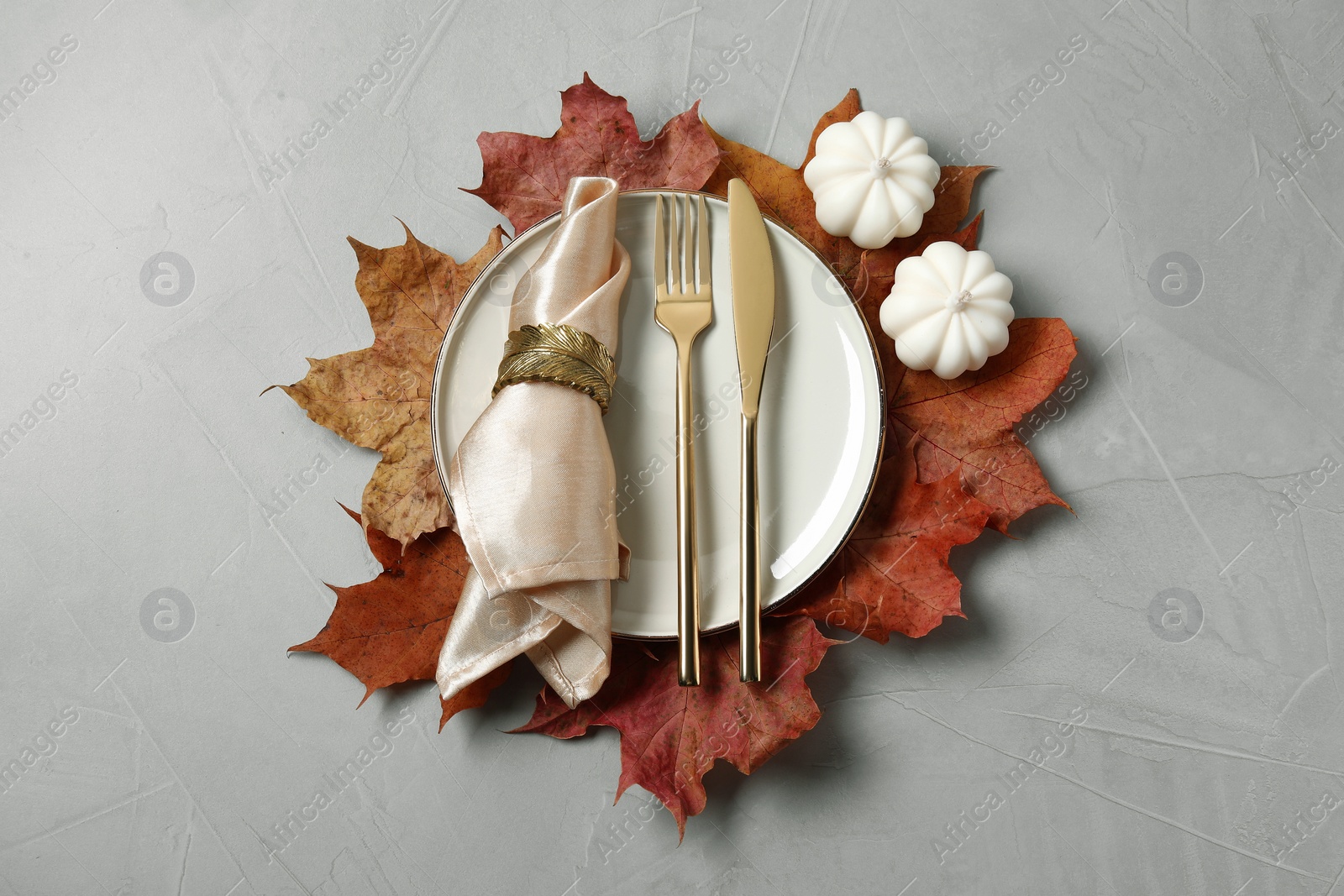 Photo of Happy Thanksgiving day. Beautiful table setting and autumn decoration on light grey background, flat lay