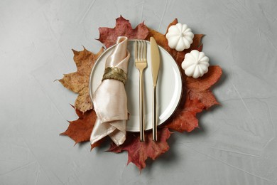 Happy Thanksgiving day. Beautiful table setting and autumn decoration on light grey background, flat lay