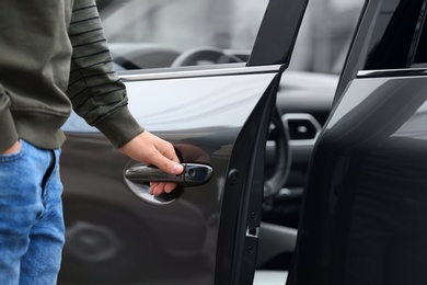 Closeup view of man opening car door