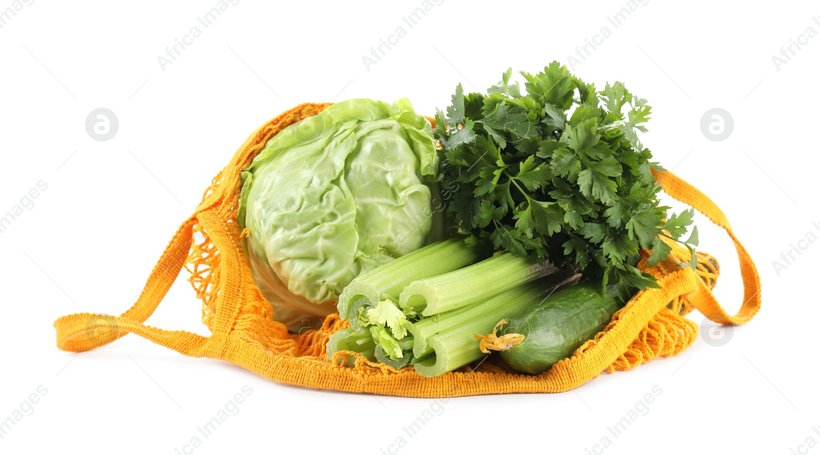 Photo of String bag with different vegetables isolated on white