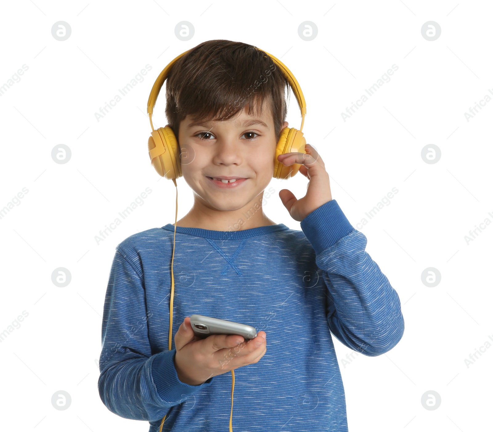 Photo of Cute little boy listening to music with headphones on white background