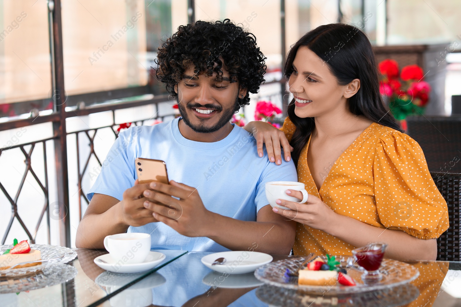 Photo of International dating. Happy couple spending time together in restaurant