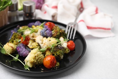 Photo of Delicious salad with cauliflower and tomato served on white table, closeup