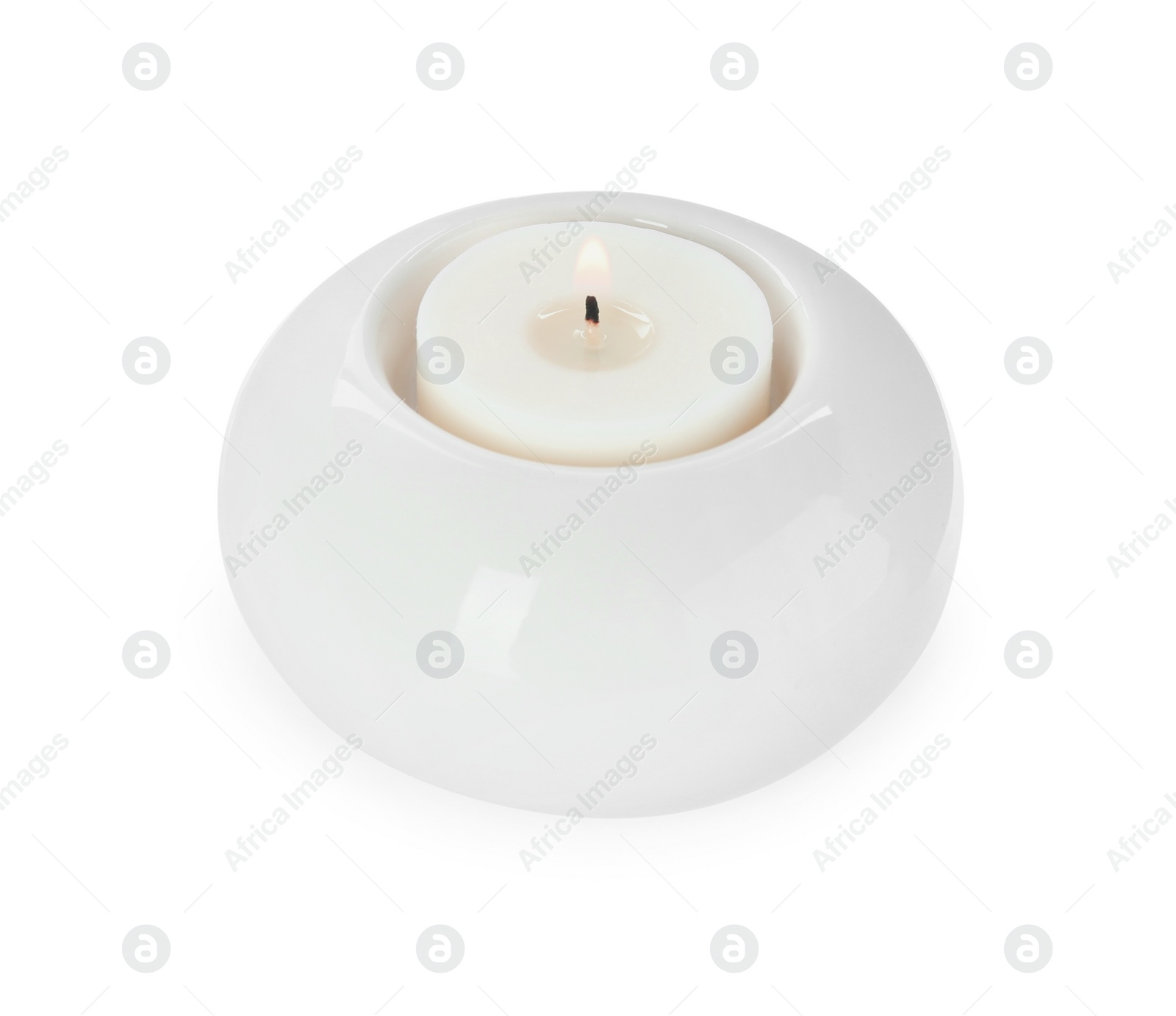 Photo of Burning candle in holder isolated on white