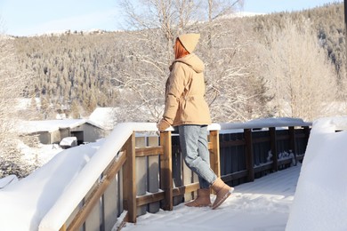 Woman standing on terrace outdoors. Winter vacation
