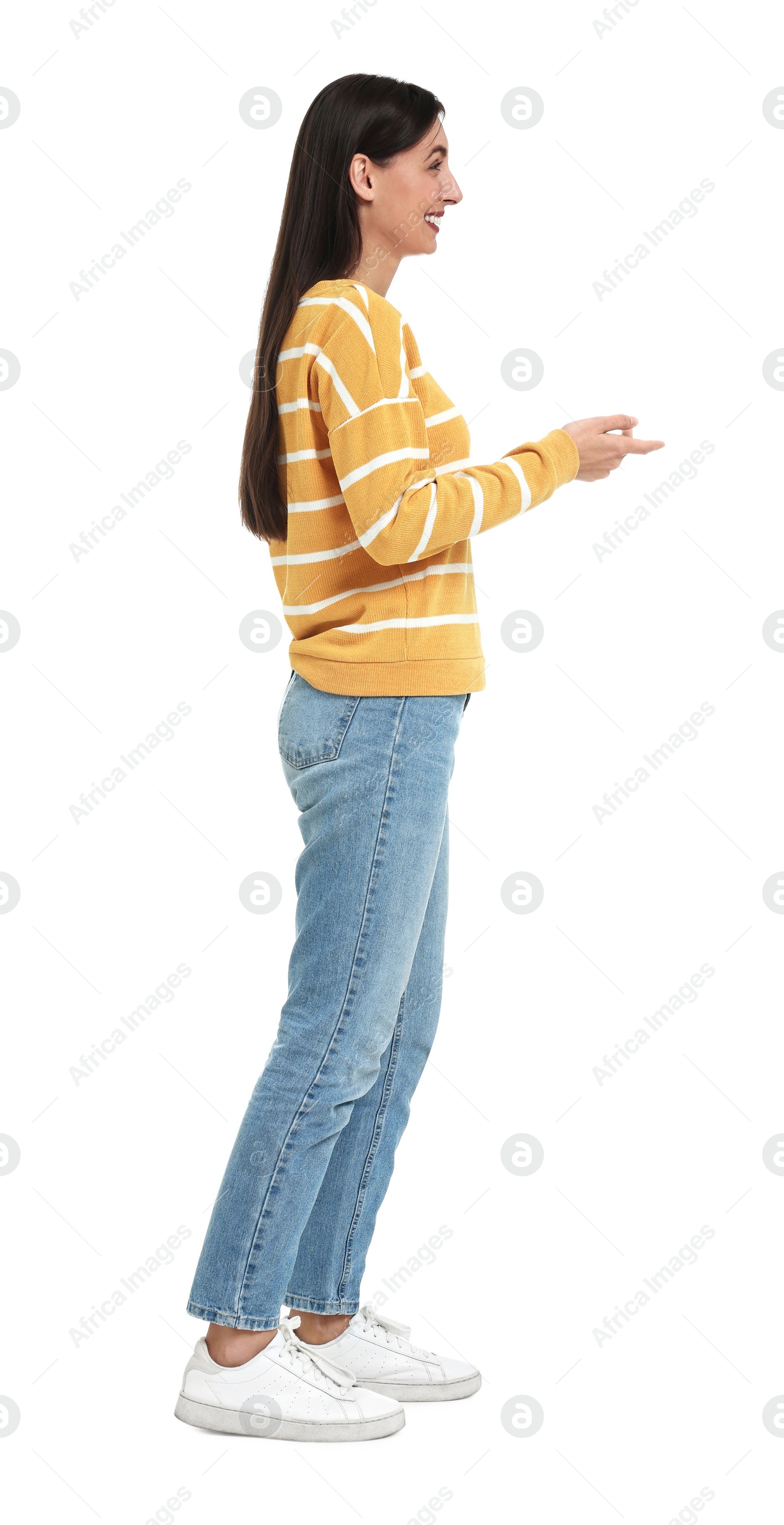 Photo of Happy woman in jeans and sweater on white background