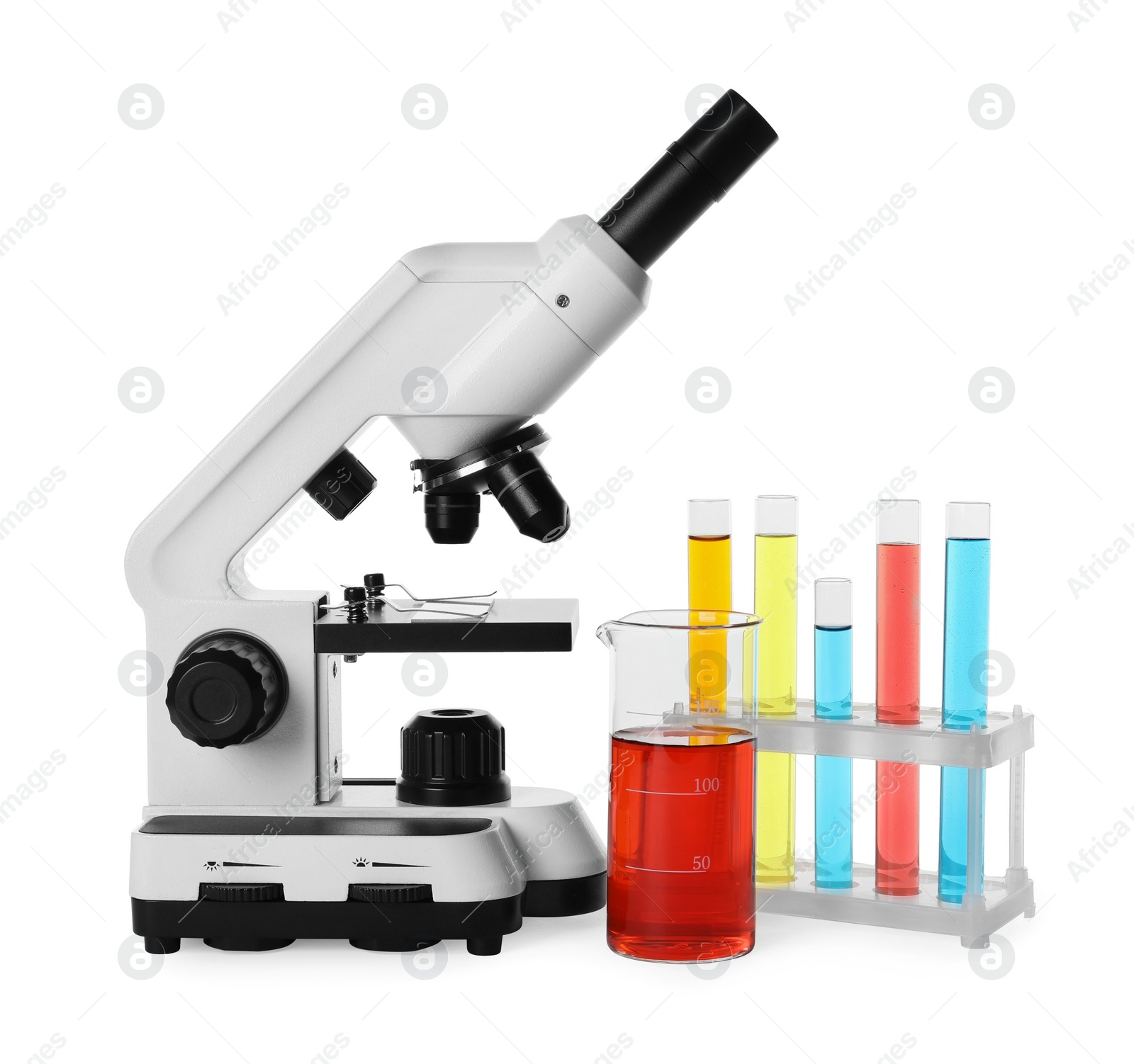 Photo of Laboratory glassware with colorful liquids and microscope isolated on white