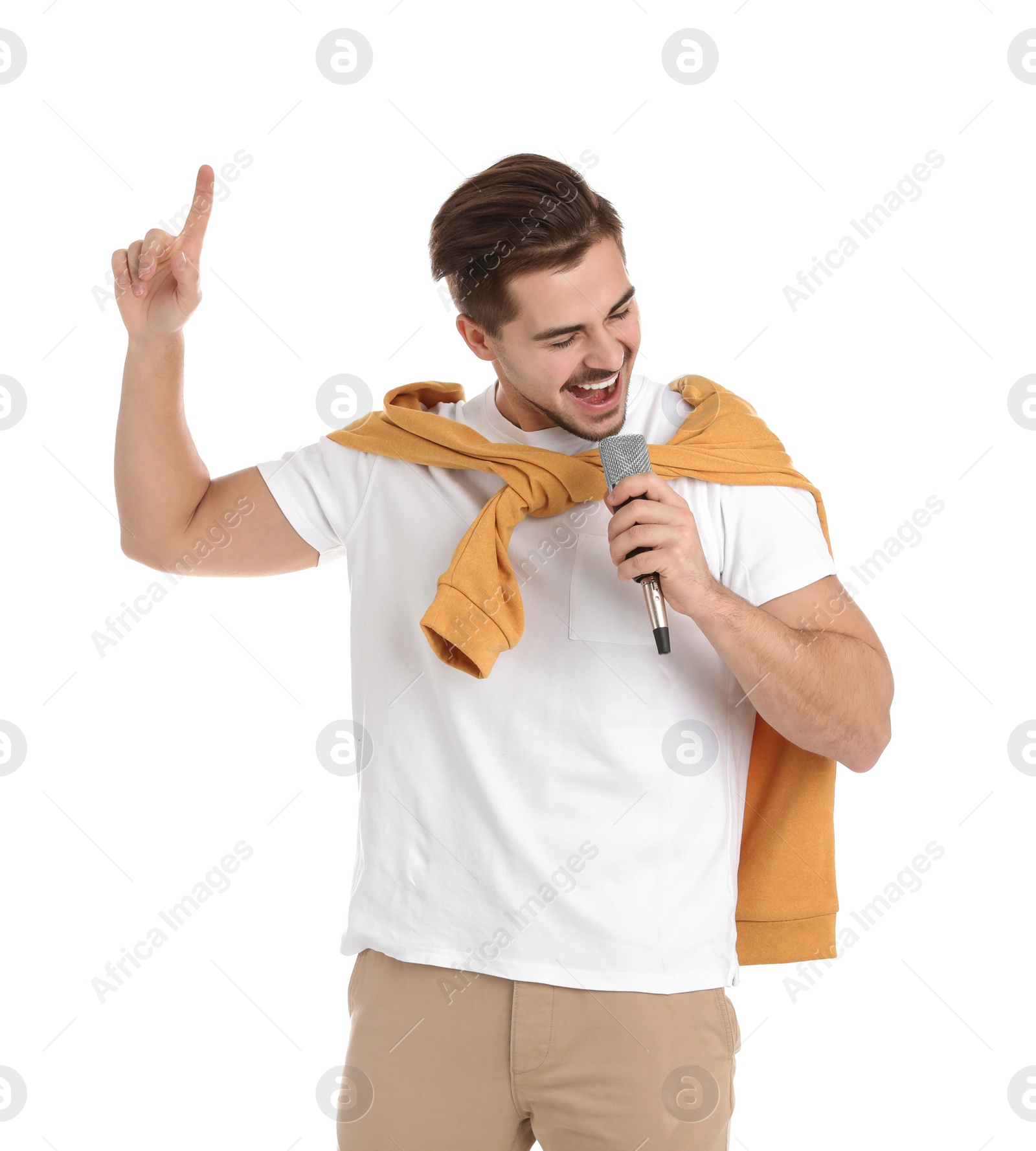 Photo of Young handsome man in casual clothes singing with microphone on white background