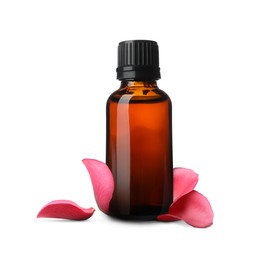 Bottle of rose essential oil and flower petals on white background