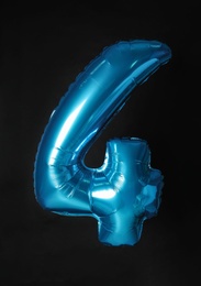 Photo of Blue number four balloon on black background