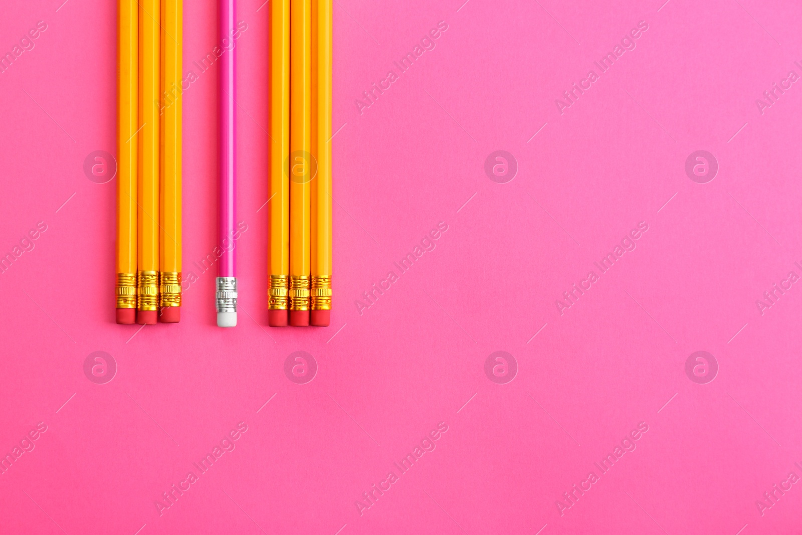 Photo of Flat lay composition with colorful pencils on pink background. Space for text