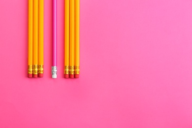 Photo of Flat lay composition with colorful pencils on pink background. Space for text