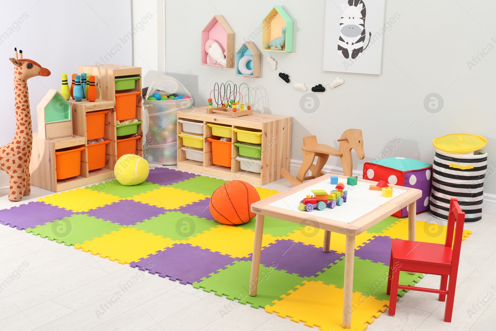 Photo of Cute child's room interior with toys and modern furniture