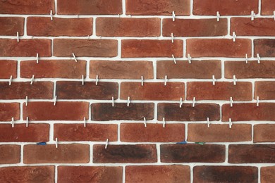Photo of Decorative bricks with tile leveling system on wall
