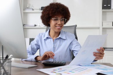 Professional accountant working at wooden desk in office