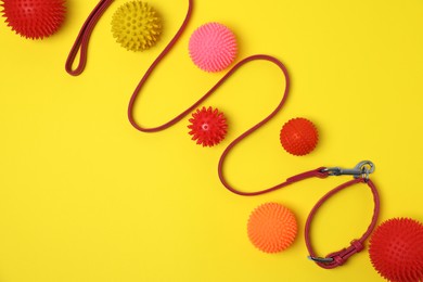 Photo of Flat lay composition with dog leash and toys on yellow background, space for text