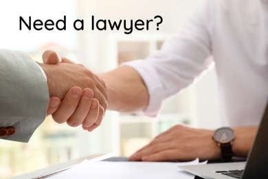 Image of Business partners shaking hands at table in office, closeup. Need a lawyer?