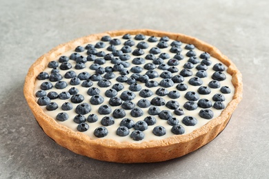 Photo of Tasty blueberry cake on gray background