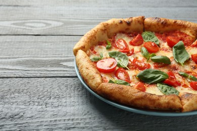 Photo of Delicious Margherita pizza on gray table, closeup. Space for text