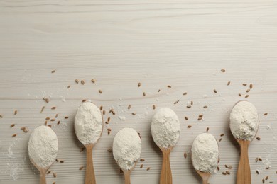 Photo of Flat lay composition with wheat flour on white wooden table. Space for text