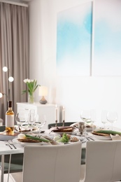 Photo of Festive Passover table setting at home. Pesach celebration