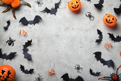 Photo of Frame made with Halloween decor elements on light grey background, flat lay. Space for text
