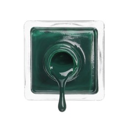 Photo of Dark green nail polish dripping from bottle isolated on white