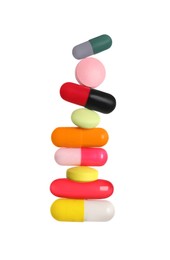 Photo of Stack of different colorful pills on white background