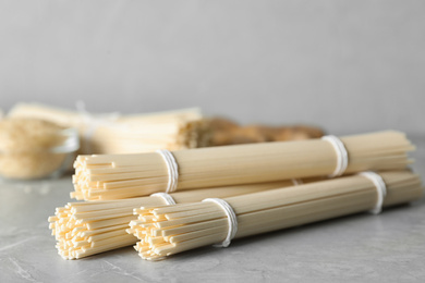 Photo of Raw rice noodles on light grey marble table
