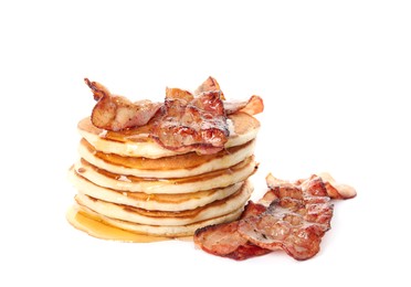 Delicious pancakes with maple syrup and fried bacon on white background