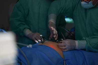 Photo of Medical team performing surgery in operating room, closeup