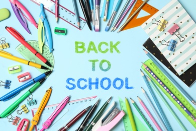 Image of Text Back To School and different stationery on light blue background, flat lay 