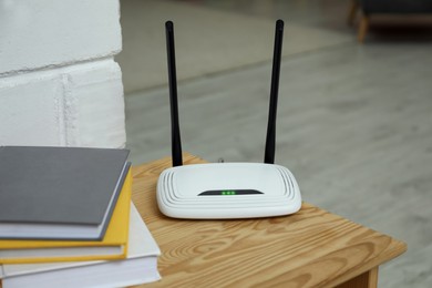 Photo of Wi-Fi router on wooden table in room