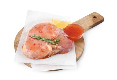 Photo of Board with raw meat, marinade, lemon and rosemary isolated on white