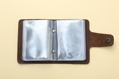 Photo of Empty leather card holder on beige background, top view