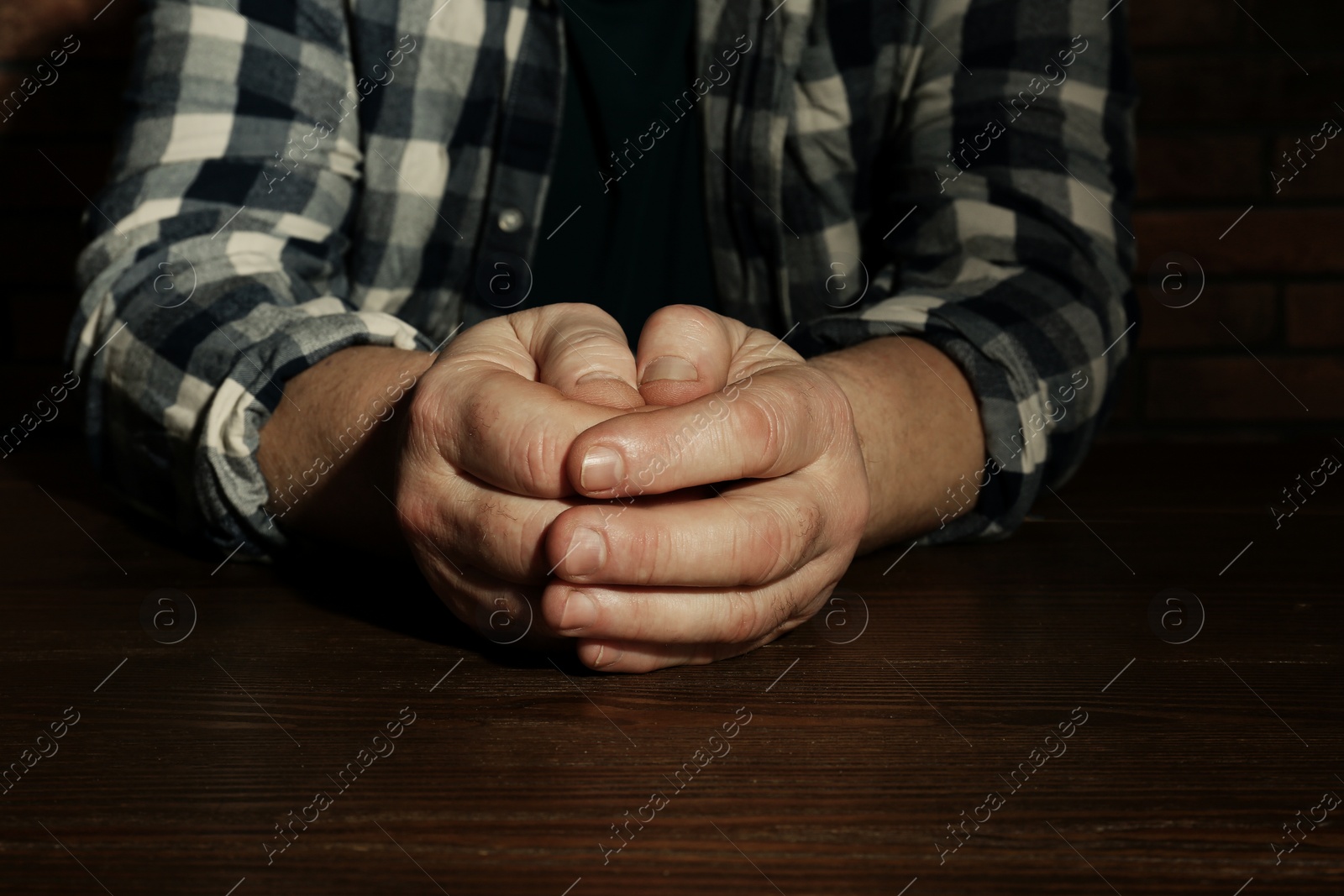 Photo of Poor senior man sitting at table, closeup