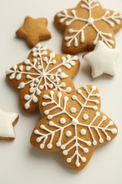 Photo of Tasty Christmas cookies with icing on white background, closeup