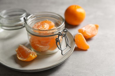 Photo of Fresh ripe tangerines on light grey table. Space for text